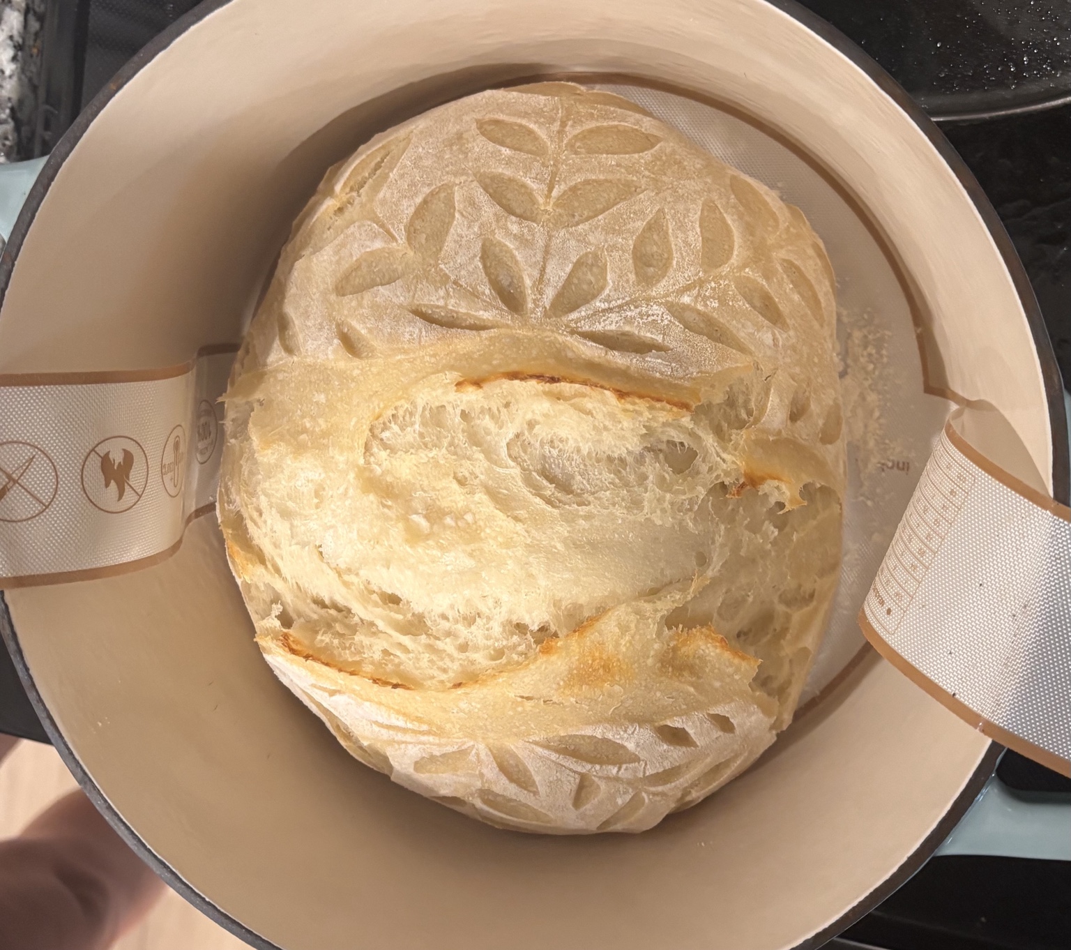 A freshly baked, scored sourdough loaf